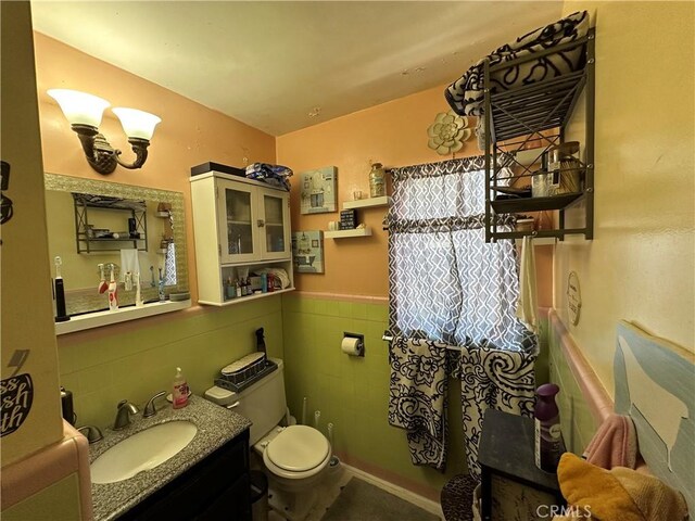 159 S Shasta St S, Willows, CA 95988 - bathroom with vanity, toilet, tile walls, and wainscoting