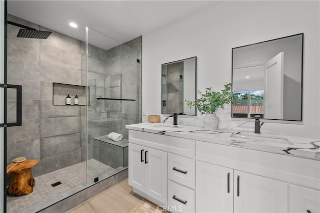 7061 Kester Ave Unit H, Van Nuys, CA 91405 - bathroom with double vanity, a stall shower, and wood finished floors