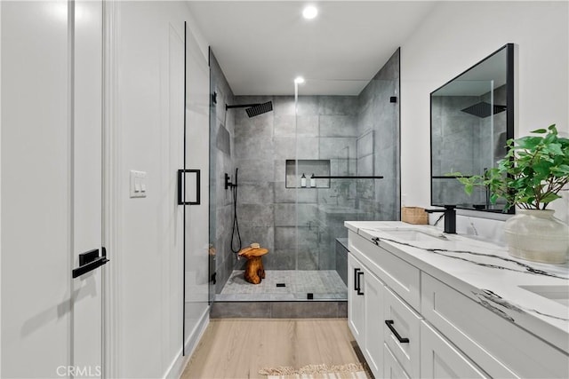 7061 Kester Ave Unit H, Van Nuys, CA 91405 - full bath with a shower stall, double vanity, wood finished floors, and recessed lighting