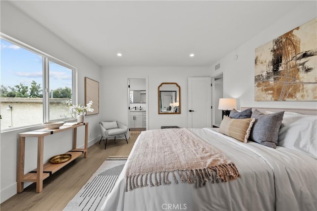 7061 Kester Ave Unit H, Van Nuys, CA 91405 - bedroom featuring light wood-style floors, recessed lighting, baseboards, connected bathroom, and a sink
