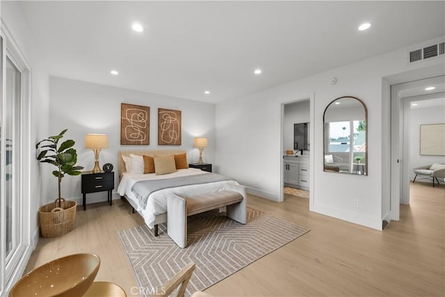7061 Kester Ave Unit H, Van Nuys, CA 91405 - bedroom featuring light wood-style floors, recessed lighting, baseboards, and ensuite bath