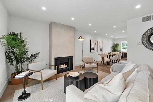 7061 Kester Ave Unit H, Van Nuys, CA 91405 - living room with light wood finished floors, recessed lighting, a fireplace, and baseboards