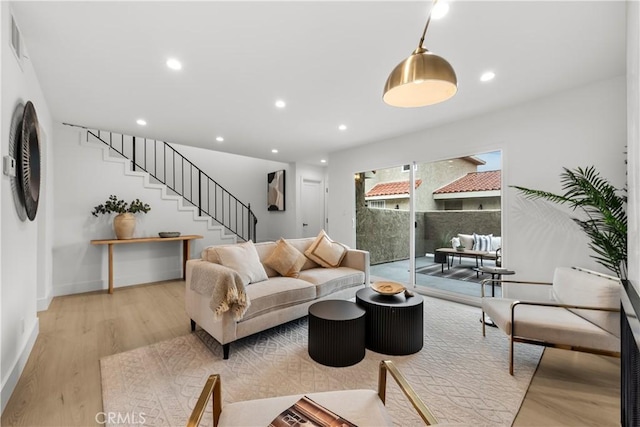 7061 Kester Ave Unit H, Van Nuys, CA 91405 - living room featuring stairway, light wood-style floors, recessed lighting, and baseboards
