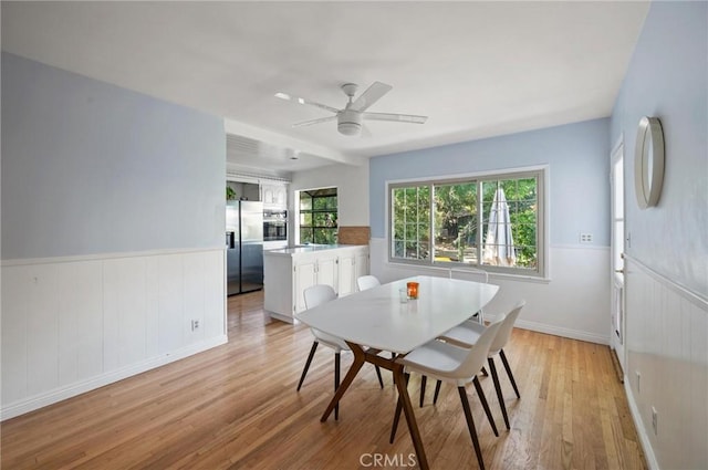 20955 De Mina St, Woodland Hills, CA 91364 - dining space with light wood-type flooring, wainscoting, and ceiling fan