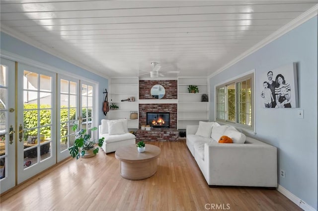 20955 De Mina St, Woodland Hills, CA 91364 - living area featuring wood finished floors, a ceiling fan, built in shelves, a fireplace, and ornamental molding