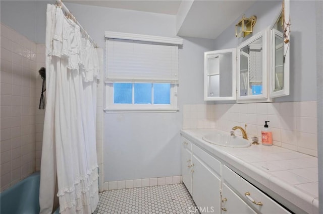 20955 De Mina St, Woodland Hills, CA 91364 - bathroom with vanity, shower / bath combo with shower curtain, tasteful backsplash, and tile patterned floors