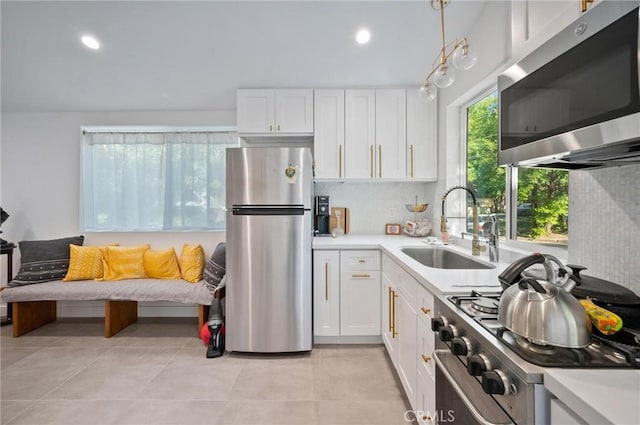 20955 De Mina St, Woodland Hills, CA 91364 - kitchen with appliances with stainless steel finishes, a sink, white cabinets, light countertops, and recessed lighting
