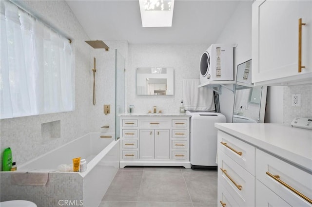 20955 De Mina St, Woodland Hills, CA 91364 - full bath featuring vanity, tile patterned flooring, bathing tub / shower combination, a skylight, and tasteful backsplash