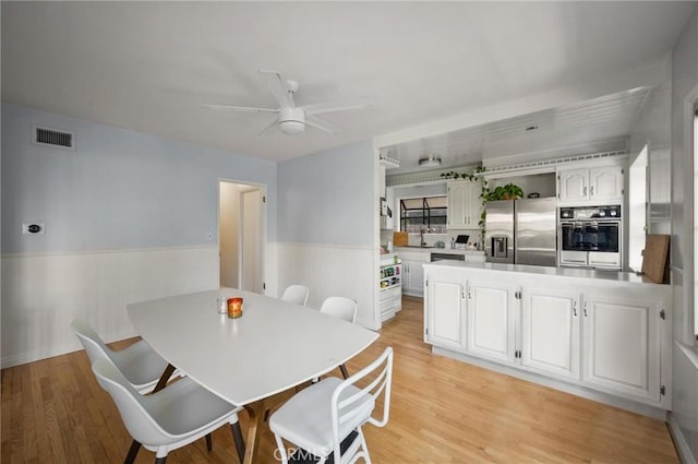 20955 De Mina St, Woodland Hills, CA 91364 - dining space featuring a wainscoted wall, ceiling fan, and light wood finished floors
