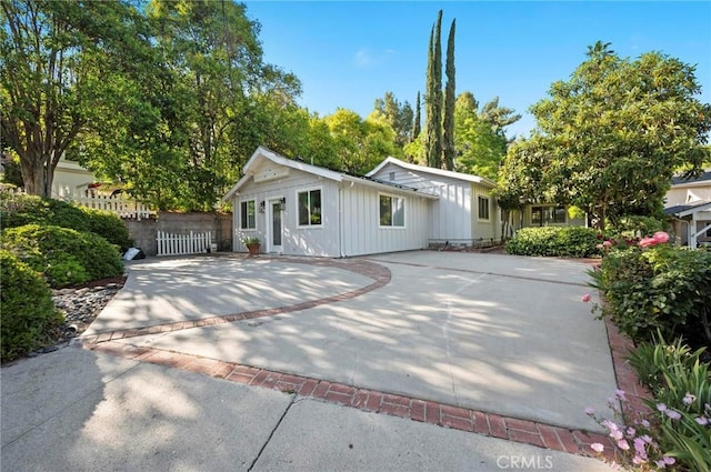 20955 De Mina St, Woodland Hills, CA 91364 - view of front of house with board and batten siding and driveway