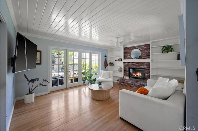 20955 De Mina St, Woodland Hills, CA 91364 - living room featuring baseboards, a fireplace, built in features, ceiling fan, and wood finished floors