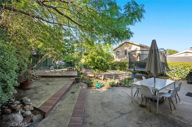 20955 De Mina St, Woodland Hills, CA 91364 - view of patio / terrace with a trampoline and outdoor dining area