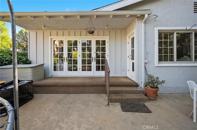 20955 De Mina St, Woodland Hills, CA 91364 - view of exterior entry with french doors, board and batten siding, and a patio