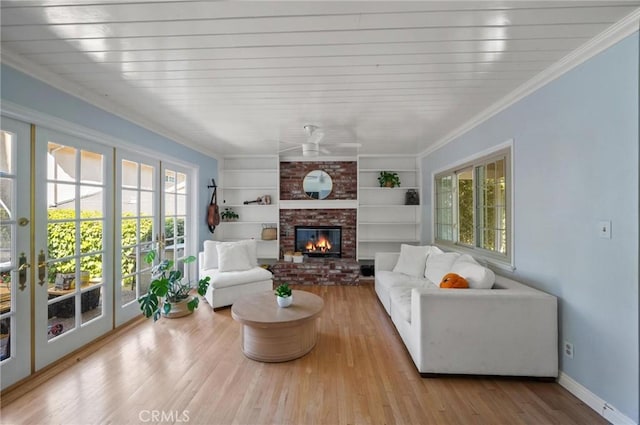 20955 De Mina St, Woodland Hills, CA 91364 - living room featuring wood finished floors, ceiling fan, a fireplace, built in shelves, and baseboards
