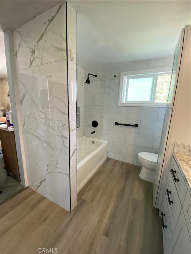 2113 N Lewis St, Santa Ana, CA 92706 - bathroom with wood finished floors, vanity, tile walls, toilet, and shower / bath combination