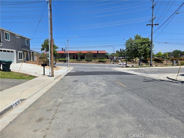 6025 Florence St, Riverside, CA 92504 - view of asphalt street featuring street lighting, curbs, and sidewalks