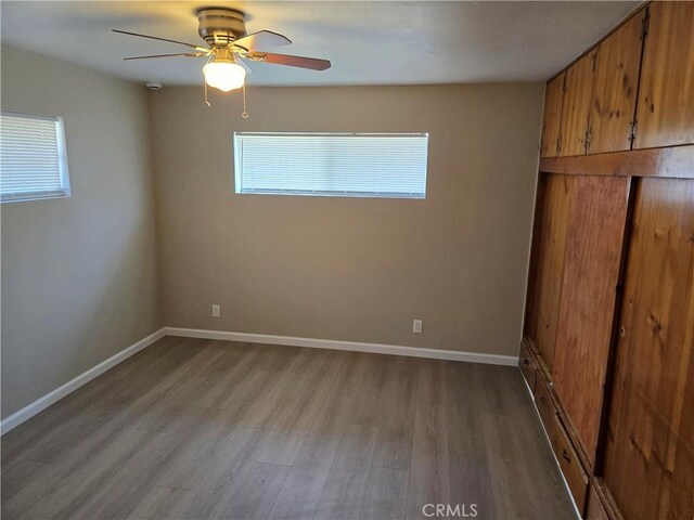 6025 Florence St, Riverside, CA 92504 - unfurnished bedroom with wood finished floors, baseboards, and ceiling fan