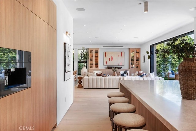 4314 Teesdale Ave, Studio City, CA 91604 - kitchen featuring modern cabinets, a kitchen breakfast bar, light wood-type flooring, and recessed lighting