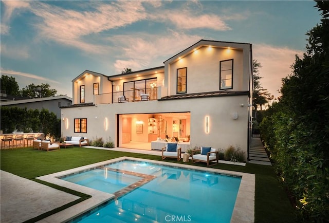 4314 Teesdale Ave, Studio City, CA 91604 - back of house at dusk with outdoor lounge area, a balcony, stucco siding, a patio, and a yard