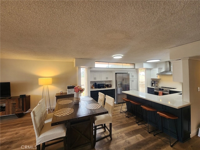 5658 Ravenspur Dr Unit 202, Rancho Palos Verdes, CA 90275 - dining space featuring a textured ceiling and wood finished floors