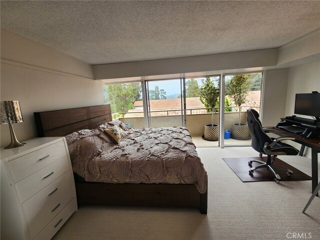 5658 Ravenspur Dr Unit 202, Rancho Palos Verdes, CA 90275 - bedroom featuring access to exterior, carpet floors, a textured ceiling, and an office area