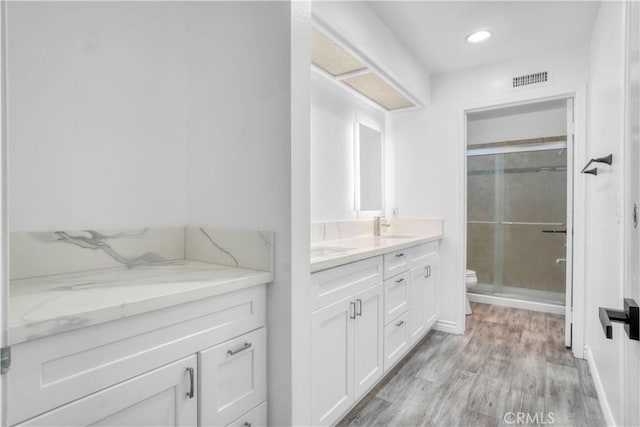 9455 Brandon Ct, Northridge, CA 91325 - bathroom featuring vanity, a shower stall, wood finished floors, and recessed lighting