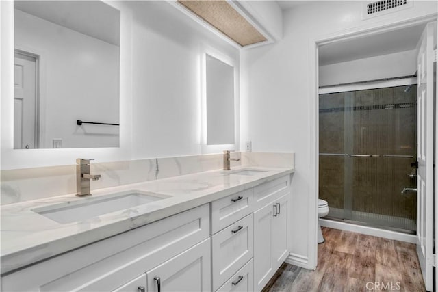 9455 Brandon Ct, Northridge, CA 91325 - bathroom featuring double vanity, a shower stall, and wood finished floors