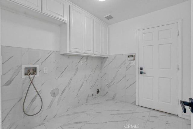 9455 Brandon Ct, Northridge, CA 91325 - laundry room featuring cabinet space, hookup for a washing machine, light marble finish flooring, and hookup for a gas dryer