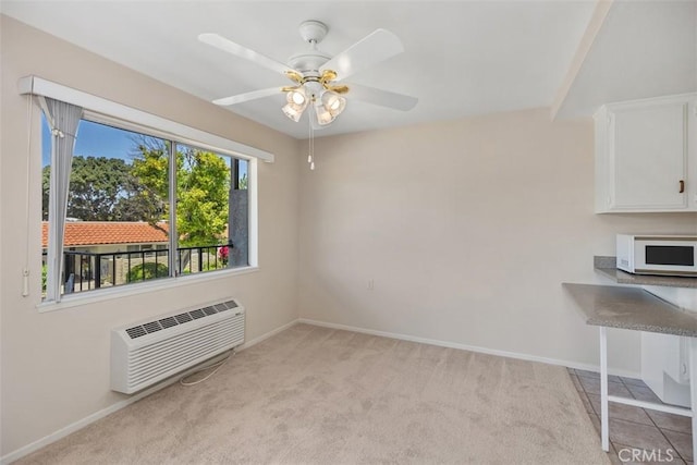 2117 Via Puerta Unit A, Laguna Woods, CA 92637 - unfurnished dining area with an AC wall unit, light colored carpet, baseboards, and a ceiling fan