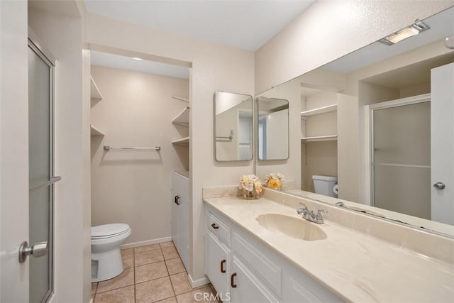 2117 Via Puerta Unit A, Laguna Woods, CA 92637 - full bathroom featuring toilet, vanity, an enclosed shower, and tile patterned floors