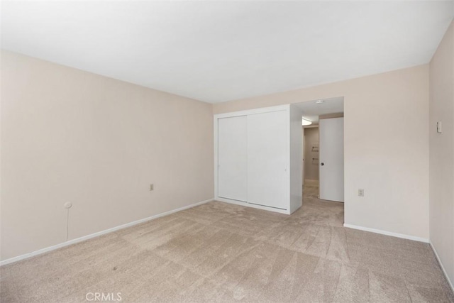 2117 Via Puerta Unit A, Laguna Woods, CA 92637 - unfurnished bedroom with light carpet, a closet, and baseboards