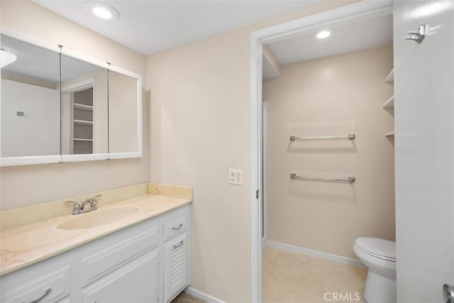 2117 Via Puerta Unit A, Laguna Woods, CA 92637 - bathroom featuring vanity, baseboards, toilet, and recessed lighting