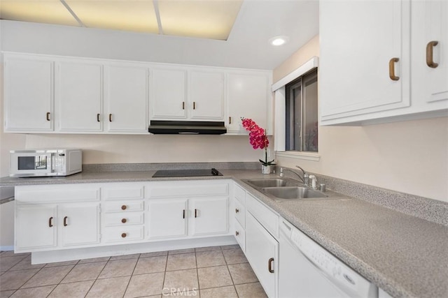 2117 Via Puerta Unit A, Laguna Woods, CA 92637 - kitchen with a sink, white appliances, under cabinet range hood, white cabinets, and light tile patterned floors