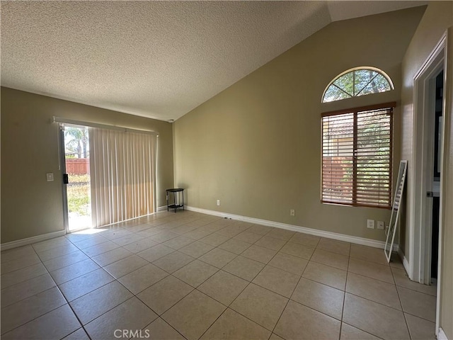 16193 Space Dr, Moreno Valley, CA 92551 - unfurnished room with vaulted ceiling, healthy amount of natural light, light tile patterned flooring, a textured ceiling, and baseboards