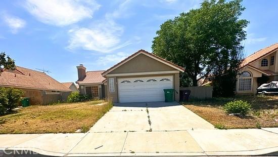 16193 Space Dr, Moreno Valley, CA 92551 - single story home featuring concrete driveway, an attached garage, and a chimney