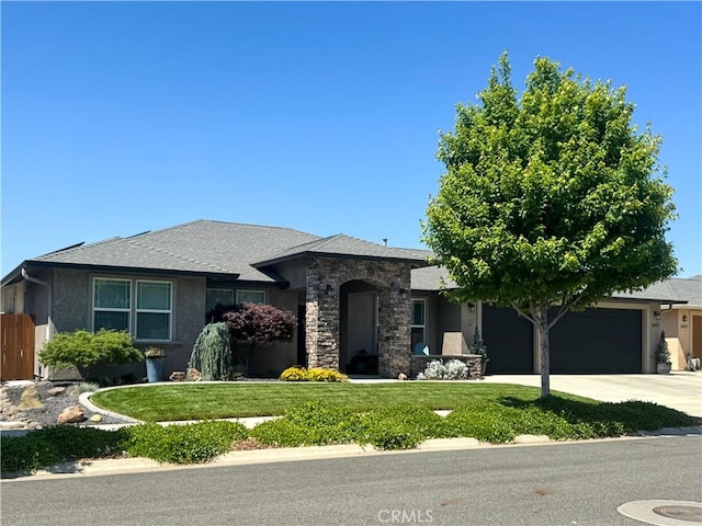 3471 Peerless Ln, Chico, CA 95973 - view of front facade featuring a garage, stucco siding, a front lawn, driveway, and stone siding
