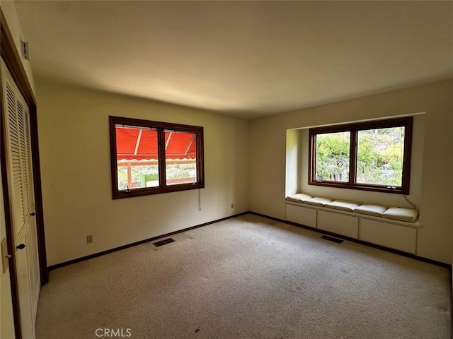 50771 Woodside Ln, Oakhurst, CA 93644 - unfurnished bedroom featuring multiple windows, carpet floors, and baseboards
