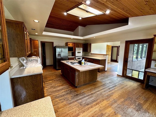 50771 Woodside Ln, Oakhurst, CA 93644 - kitchen with white appliances, wood ceiling, a kitchen island, dark wood-style flooring, and recessed lighting