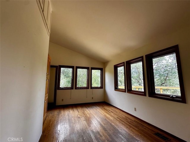 50771 Woodside Ln, Oakhurst, CA 93644 - empty room with wood finished floors, vaulted ceiling, and baseboards
