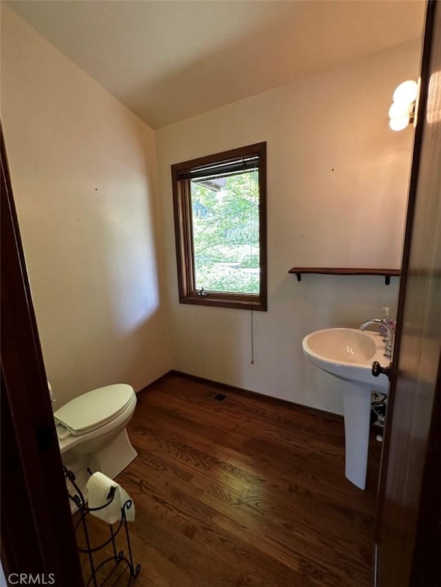 50771 Woodside Ln, Oakhurst, CA 93644 - bathroom with wood finished floors, toilet, and baseboards