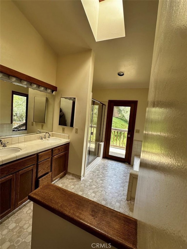 50771 Woodside Ln, Oakhurst, CA 93644 - bathroom with tile patterned floors, plenty of natural light, double vanity, and a shower stall