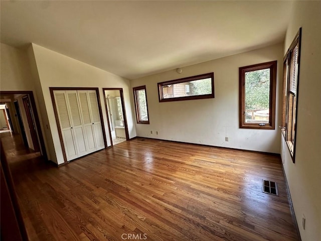 50771 Woodside Ln, Oakhurst, CA 93644 - unfurnished bedroom featuring dark wood-type flooring, lofted ceiling, baseboards, and ensuite bath