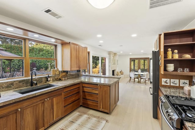 233233A Cole Ranch Rd, Encinitas, CA 92024 - kitchen featuring a sink, recessed lighting, a peninsula, stainless steel gas range, and brown cabinets