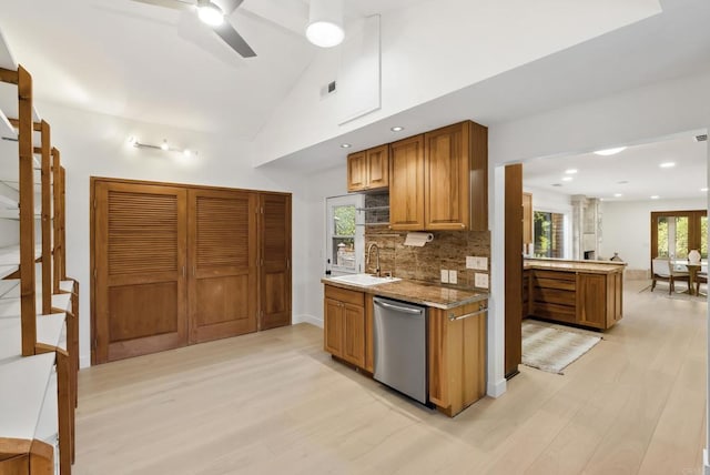 233233A Cole Ranch Rd, Encinitas, CA 92024 - kitchen featuring stainless steel dishwasher, a sink, light wood-style flooring, brown cabinets, and vaulted ceiling