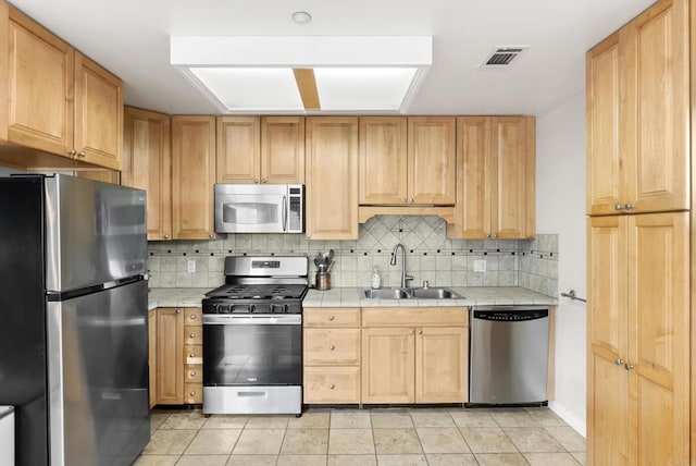 233233A Cole Ranch Rd, Encinitas, CA 92024 - kitchen with stainless steel appliances, a sink, tile counters, backsplash, and light tile patterned floors