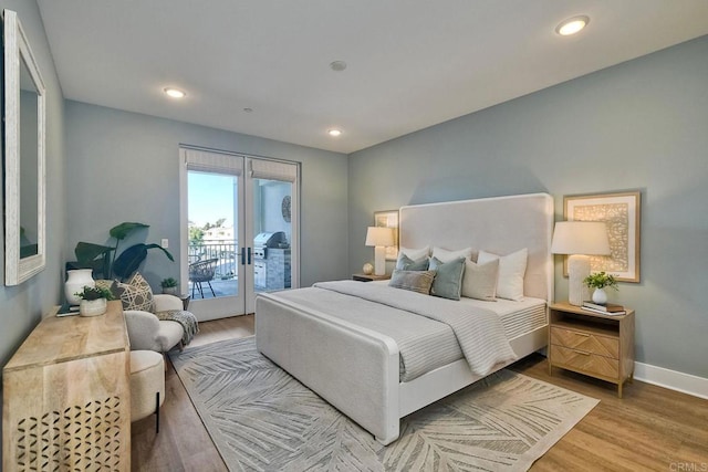 800 Grand Ave Unit 205, Carlsbad, CA 92008 - bedroom featuring access to outside, baseboards, wood finished floors, recessed lighting, and french doors