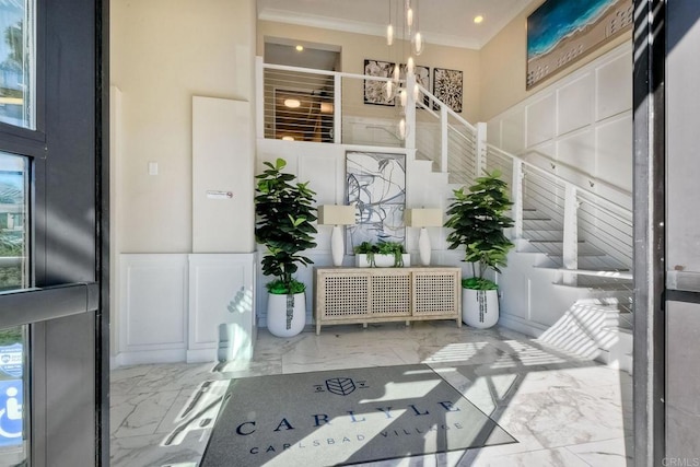 800 Grand Ave Unit 205, Carlsbad, CA 92008 - entrance foyer featuring marble tiled floors, ornamental molding, a chandelier, and stairway