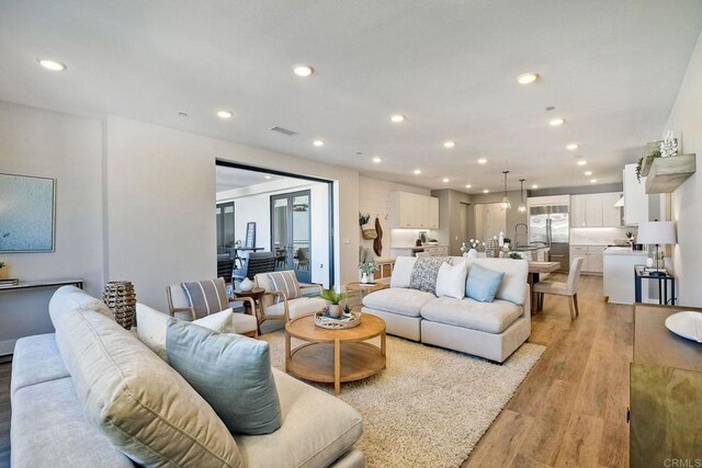 800 Grand Ave Unit 205, Carlsbad, CA 92008 - living room with light wood-style floors and recessed lighting
