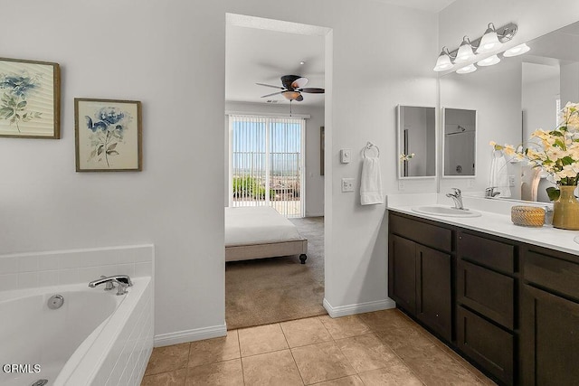 953 Coronado Cir, Santa Paula, CA 93060 - ensuite bathroom featuring double vanity, a bath, ceiling fan, tile patterned floors, and baseboards