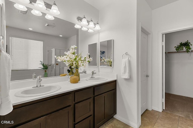 953 Coronado Cir, Santa Paula, CA 93060 - bathroom with a stall shower, double vanity, a walk in closet, and tile patterned flooring